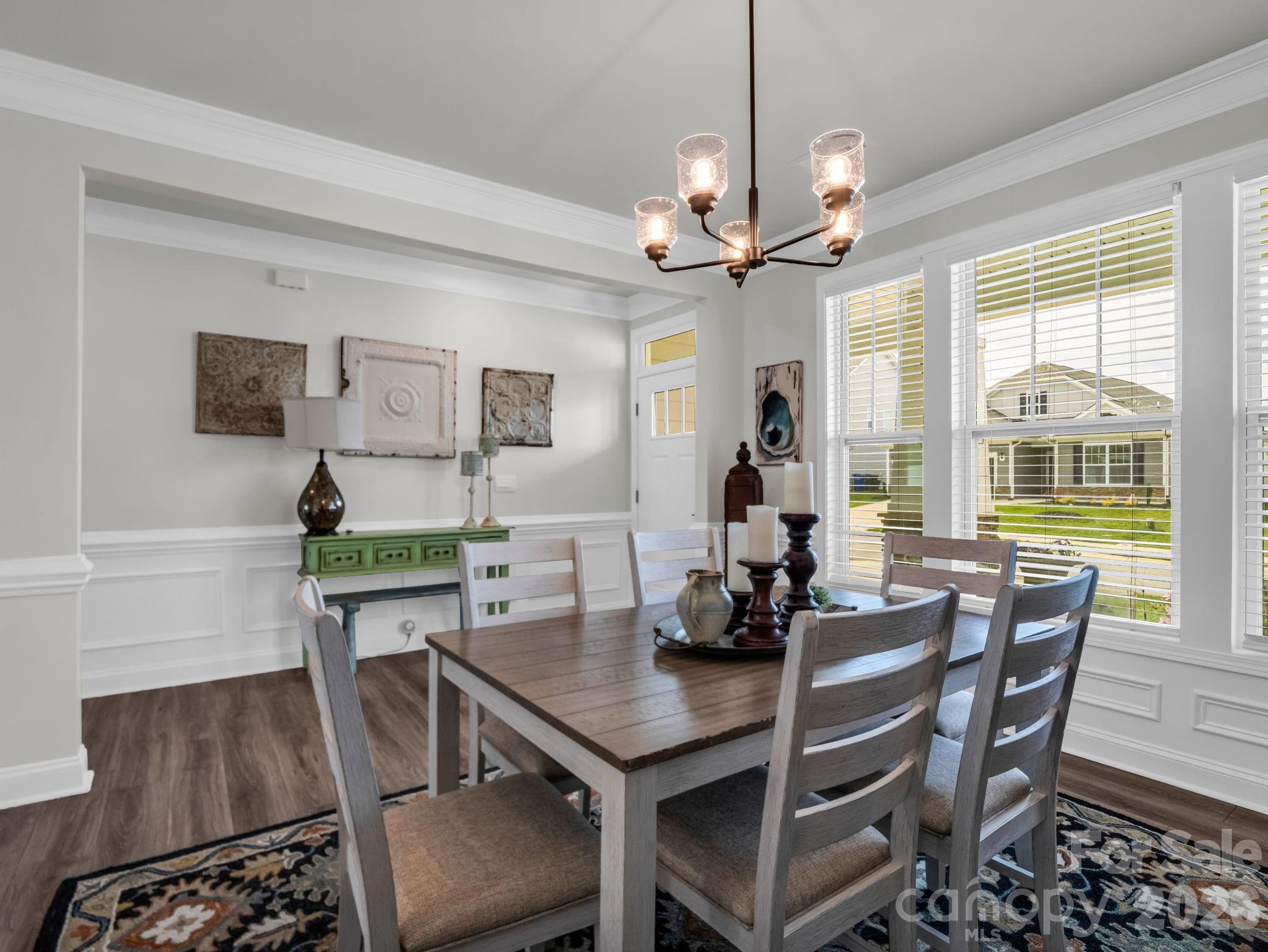 383 Fox Cove Road Hendersonville, NC 28792 - Photo 6 of 34 a view of a dining room with furniture a chandelier and wooden floor