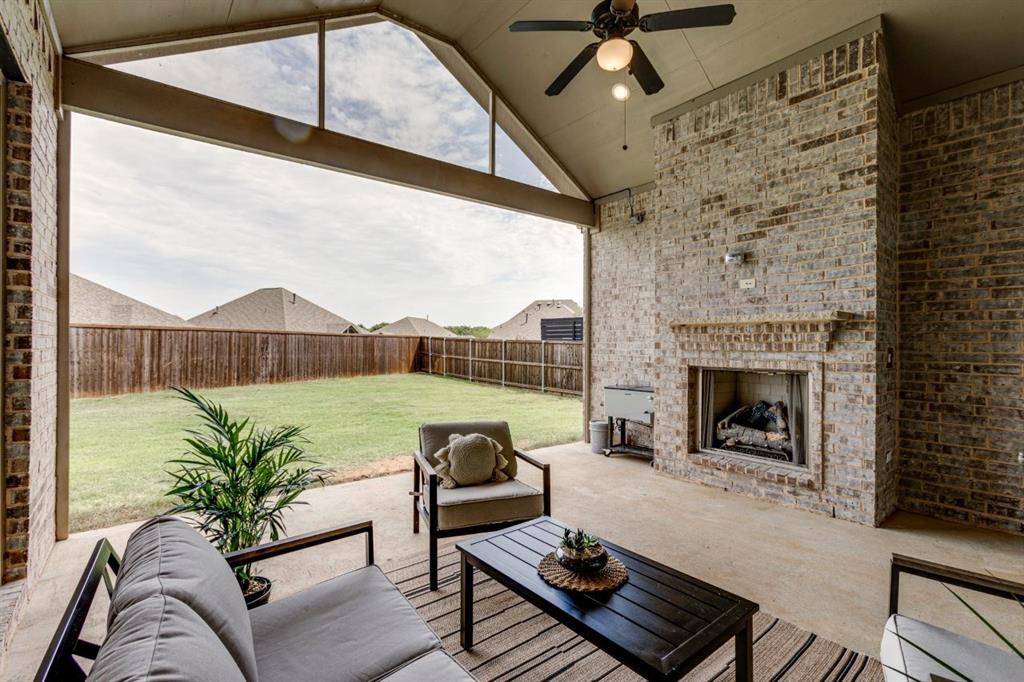 9613 Boulder Pt Road Oak Point, TX 75068 - Photo 14 of 28 Covered patio featuring an outdoor brick fireplace, vaulted ceiling, and concrete flooring