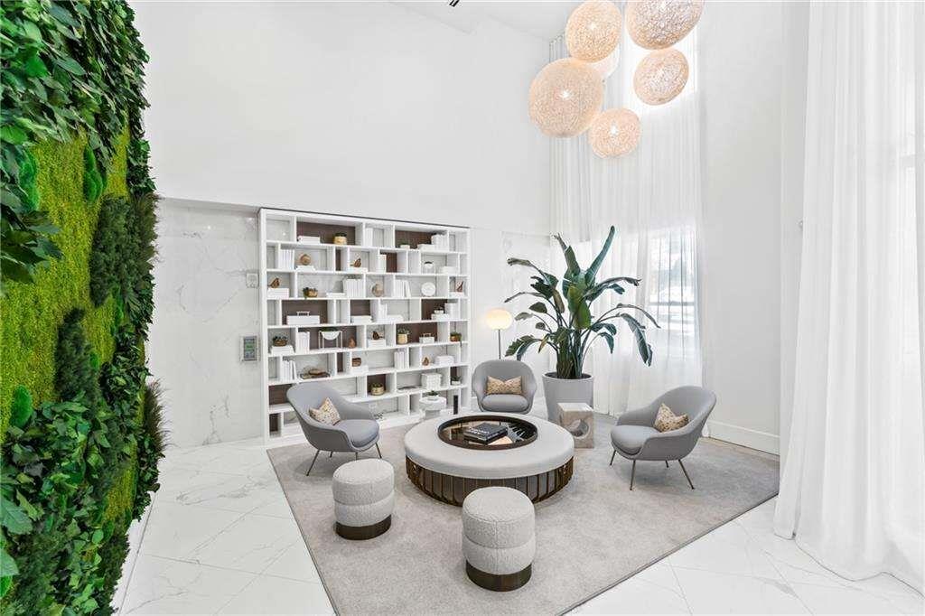 775 Juniper Street Northeast, Unit 212 Atlanta, GA 30308 - Photo 13 of 41 a living room with furniture and a potted plant