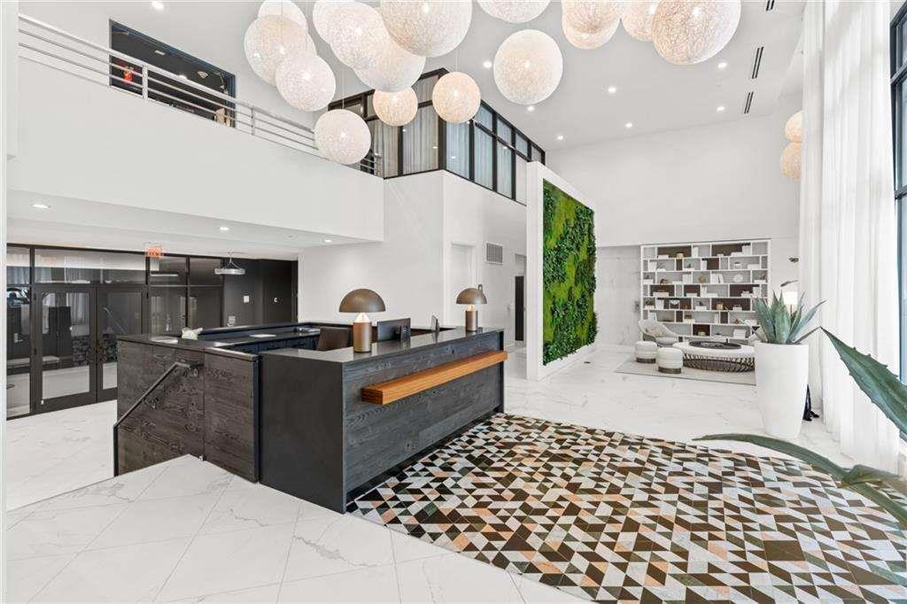 775 Juniper Street Northeast, Unit 212 Atlanta, GA 30308 - Photo 14 of 41 a large white kitchen with lots of appliances and cabinets
