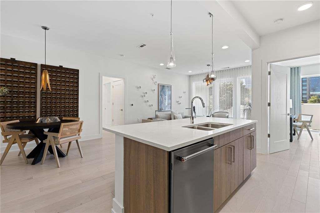 775 Juniper Street Northeast, Unit 212 Atlanta, GA 30308 - Photo 3 of 41 a kitchen with a sink a table and chairs