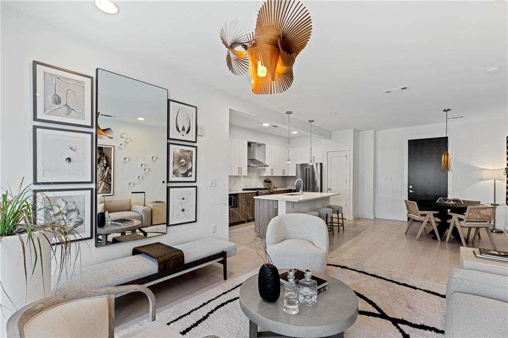 775 Juniper Street Northeast, Unit 212 Atlanta, GA 30308 - Photo 6 of 41 a living room with furniture kitchen view and a dining table