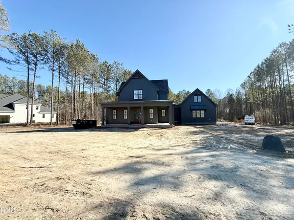 a front view of a house with a yard covered in snow