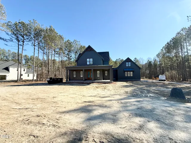 a front view of a house with a yard covered in snow