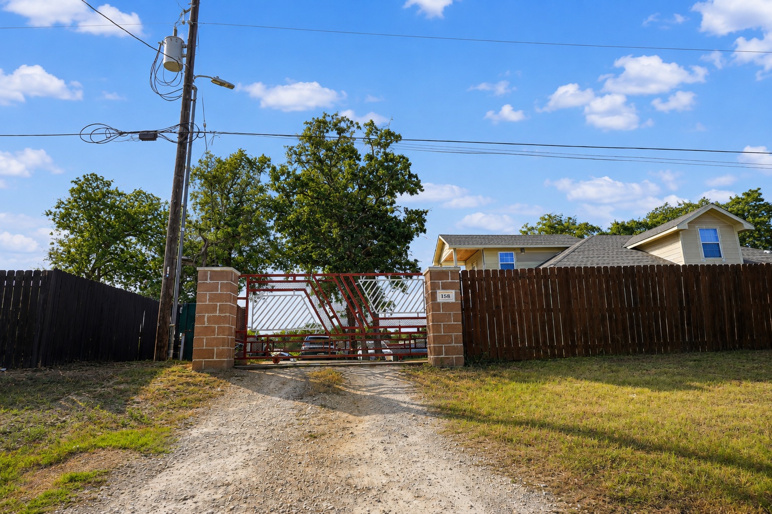 158 Buena Fortuna Road Elgin, TX 78621 - Photo 7 of 40 A private, fenced property offers secluded living with a home nestled among mature trees.