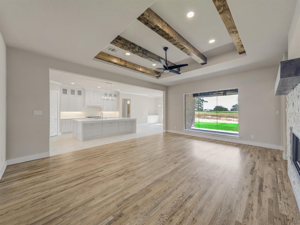 1000 Henry Way Springtown, TX 76082 - Photo 11 of 38 a view of an empty room with a window and wooden floor