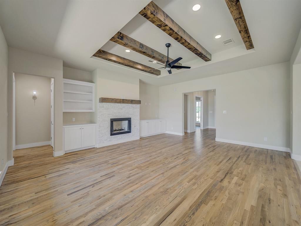 1000 Henry Way Springtown, TX 76082 - Photo 13 of 38 wooden floor in an empty room with a fireplace