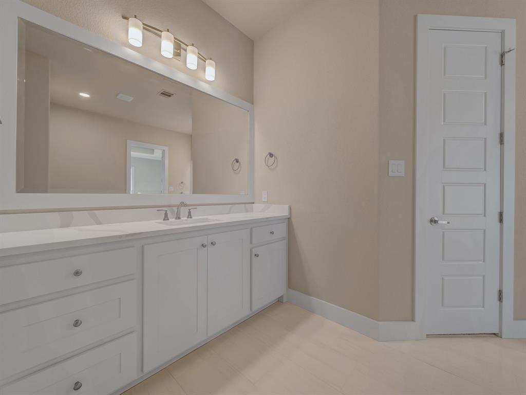 1000 Henry Way Springtown, TX 76082 - Photo 21 of 38 a spacious bathroom with a double vanity sink and a mirror