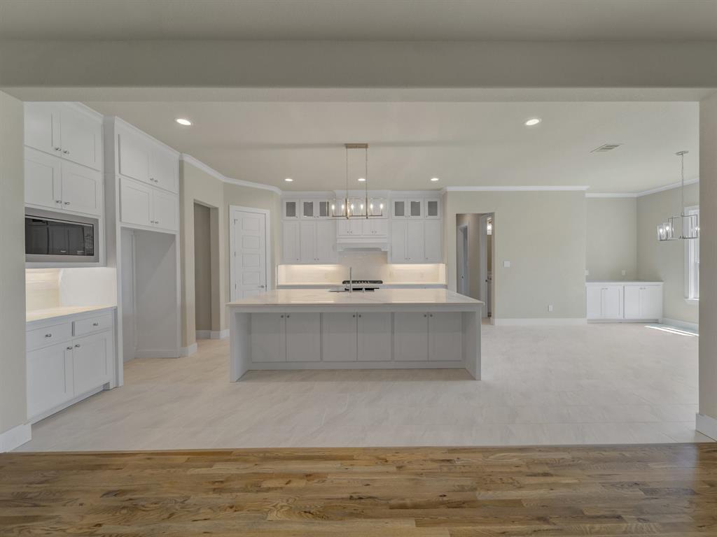 1000 Henry Way Springtown, TX 76082 - Photo 26 of 38 a large kitchen with stainless steel appliances kitchen island a large counter top and a stove top oven