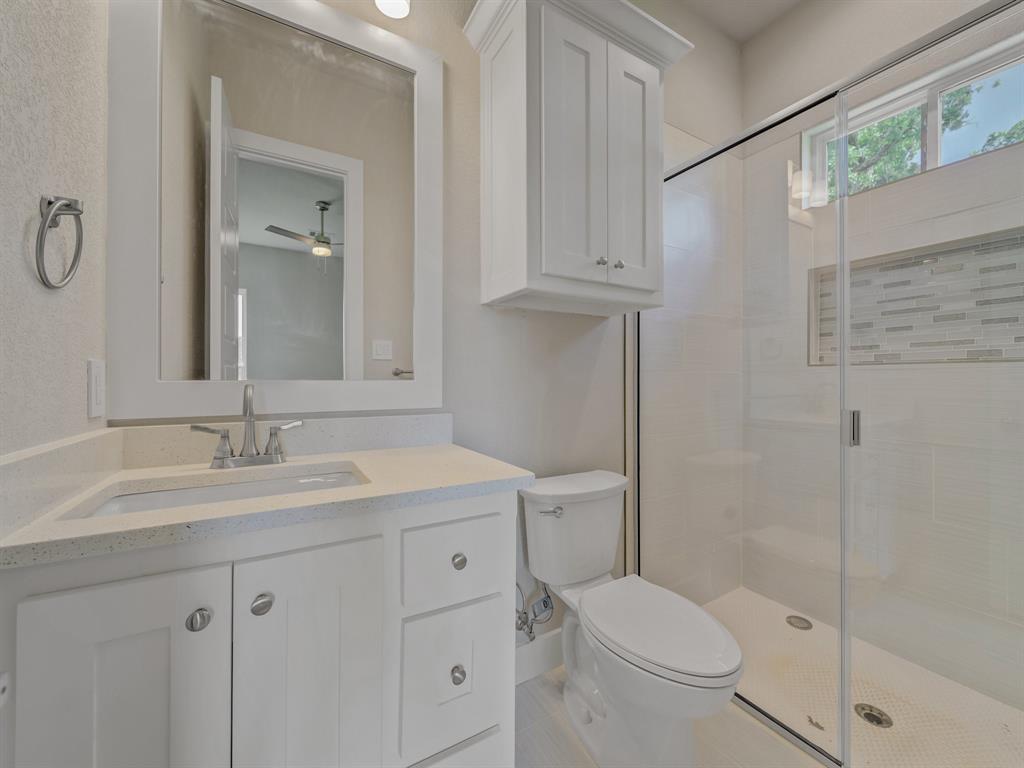 1000 Henry Way Springtown, TX 76082 - Photo 34 of 38 a bathroom with a granite countertop sink toilet and shower