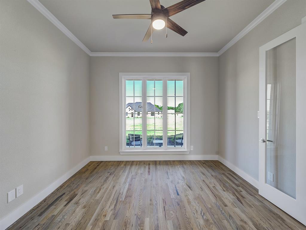 1000 Henry Way Springtown, TX 76082 - Photo 6 of 38 a view of an empty room with wooden floor and a window