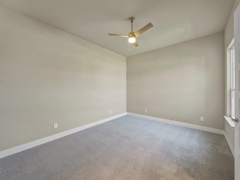 1000 Henry Way Springtown, TX 76082 - Photo 8 of 38 an empty room with a window and a fan