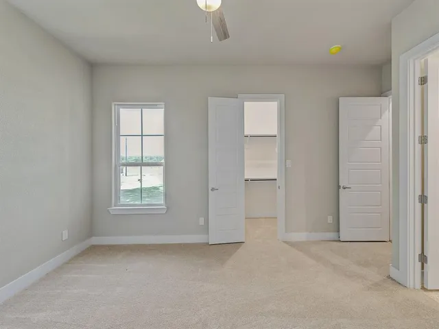 an empty room with windows and closet