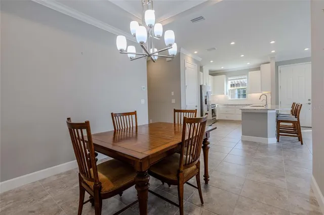 a view of a dining room with furniture and chandelier