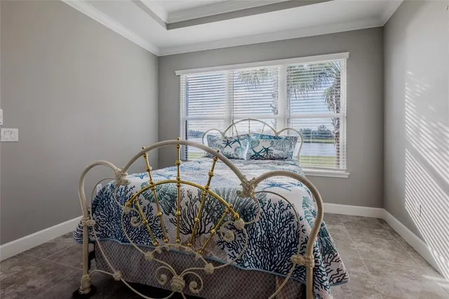 a bed sitting in a bedroom next to a window