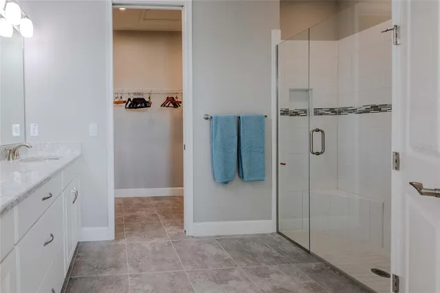 a bathroom with a shower and a sink