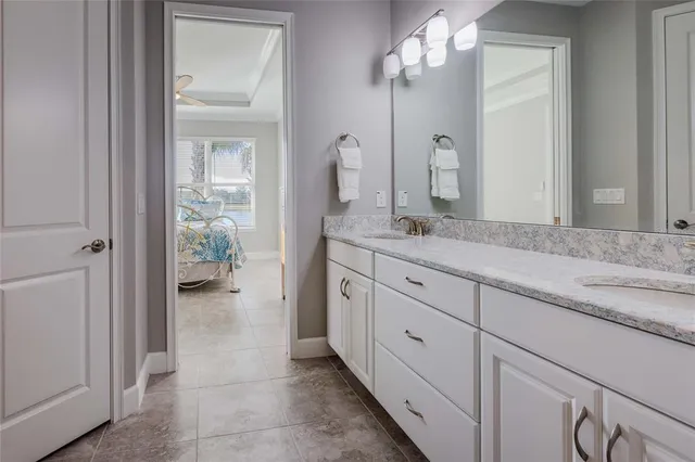 a spacious bathroom with a granite countertop sink a mirror and shower