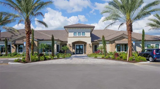 a front view of a house with garden and trees