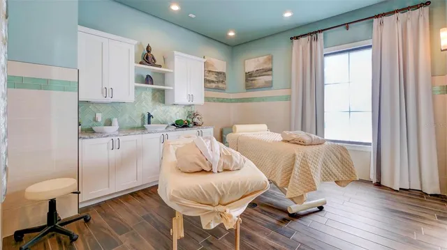 a bedroom with wooden floor and a bed