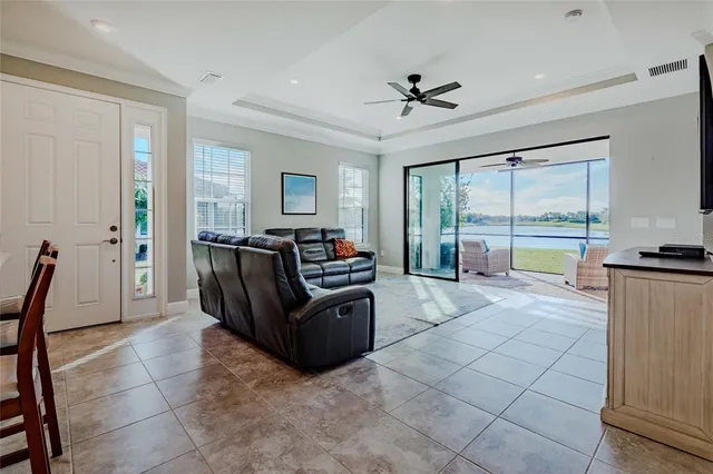 a living room with furniture and a floor to ceiling window