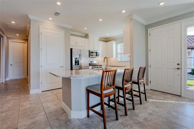 a large kitchen with a table and chairs