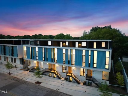 a view of a brick house with a chairs