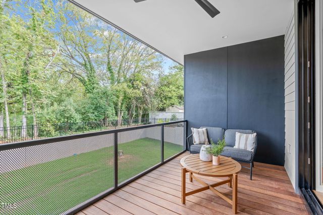 a view of a chair and tables in the balcony