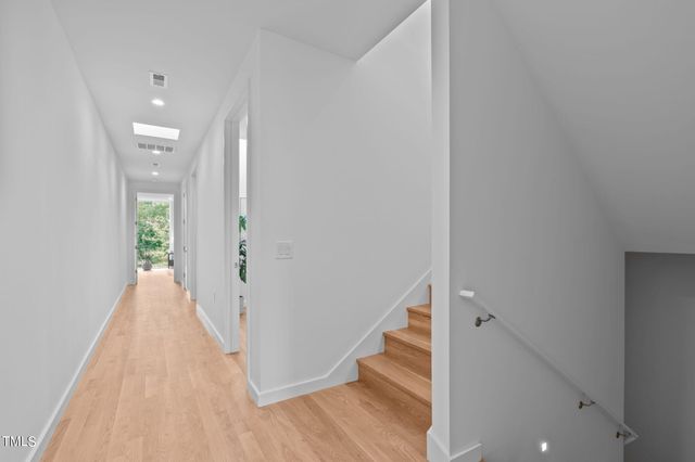 a bedroom with a bed and a potted plant