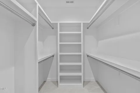 a spacious bathroom with a double vanity sink and a mirror