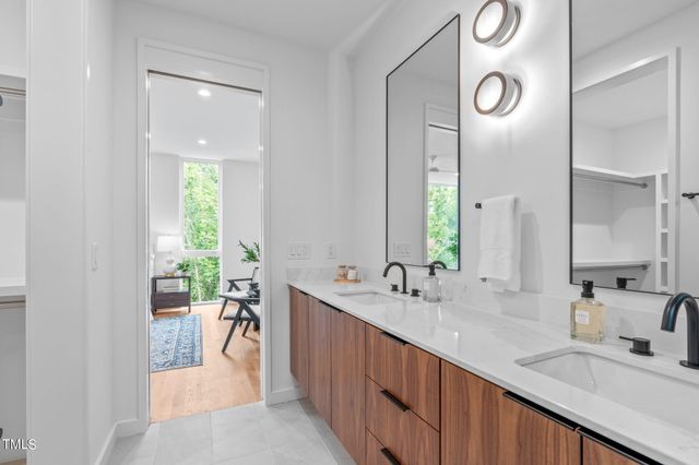a view of a room with a dining table and chairs