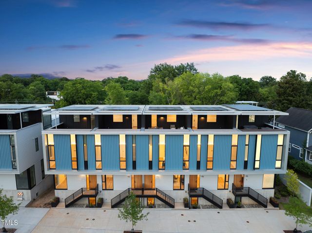 a view of a patio with a table and chairs under an umbrella
