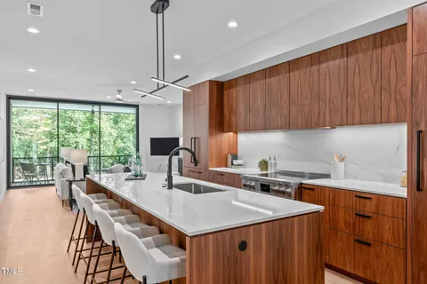 a kitchen with a stove a sink a dining table and chairs