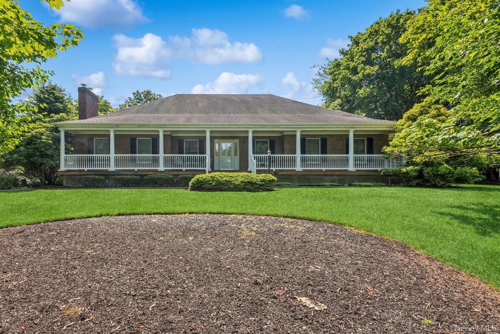 a view of house with a yard and potted plants