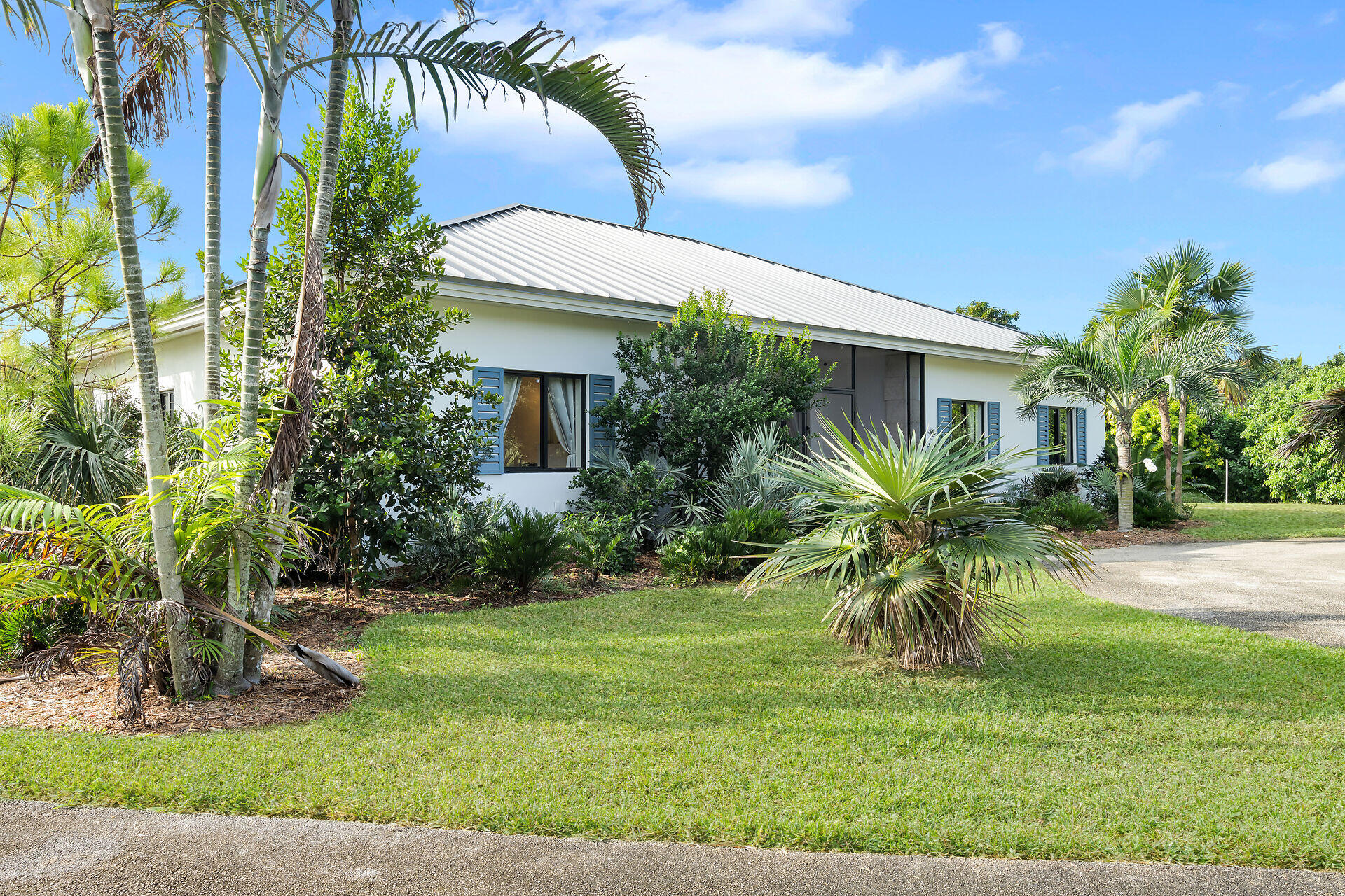 19900 Southwest 280th Street Homestead, FL 33031 - Photo 11 of 52 a palm tree sitting in front of a house with a big yard