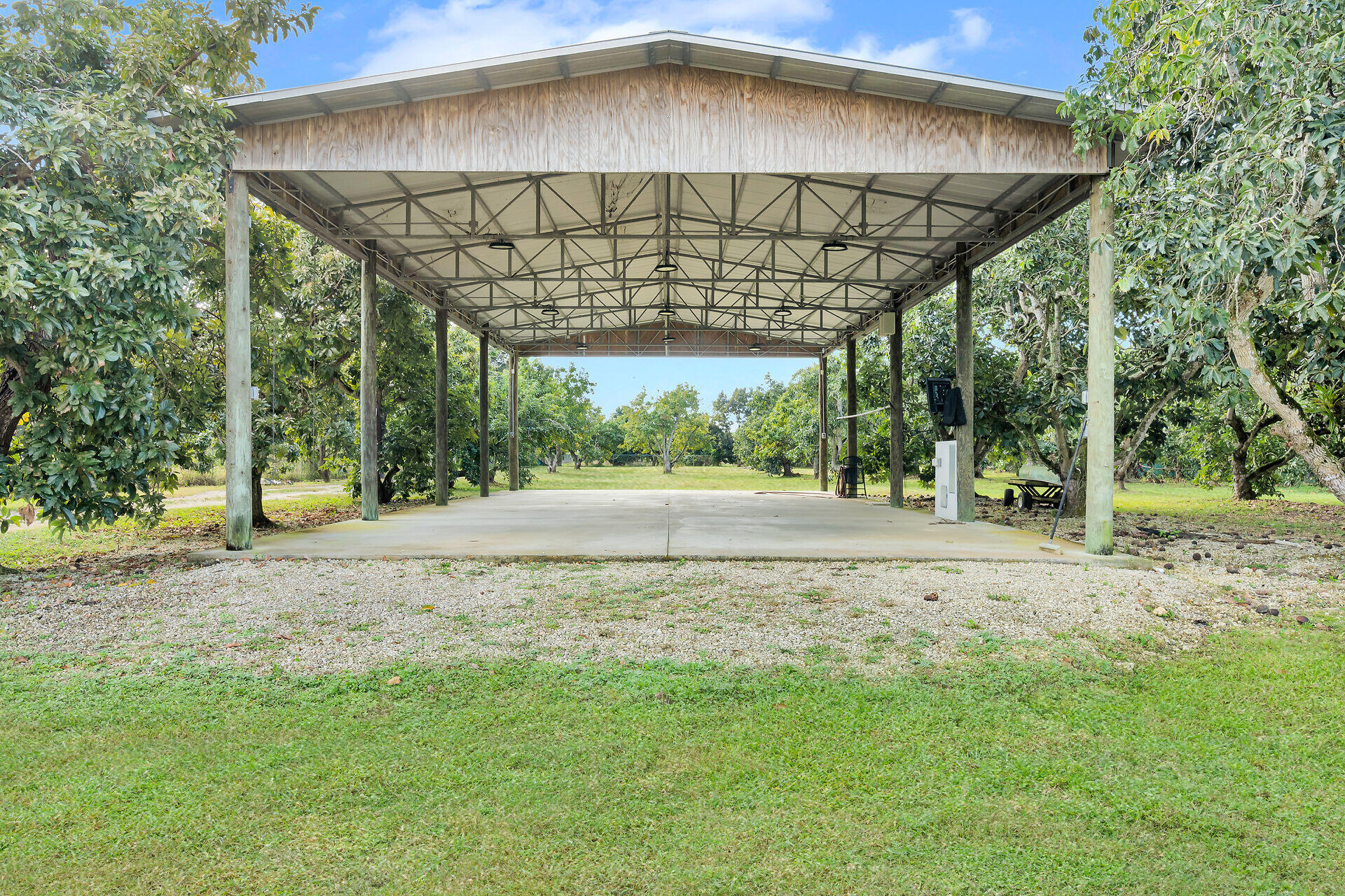19900 Southwest 280th Street Homestead, FL 33031 - Photo 14 of 52 a view of a big yard under an umbrella