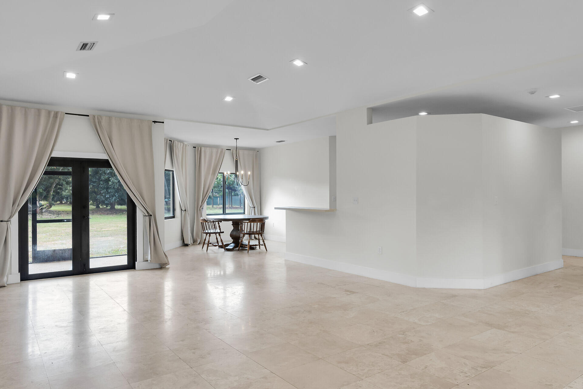 19900 Southwest 280th Street Homestead, FL 33031 - Photo 18 of 52 an empty room with wooden floor and windows