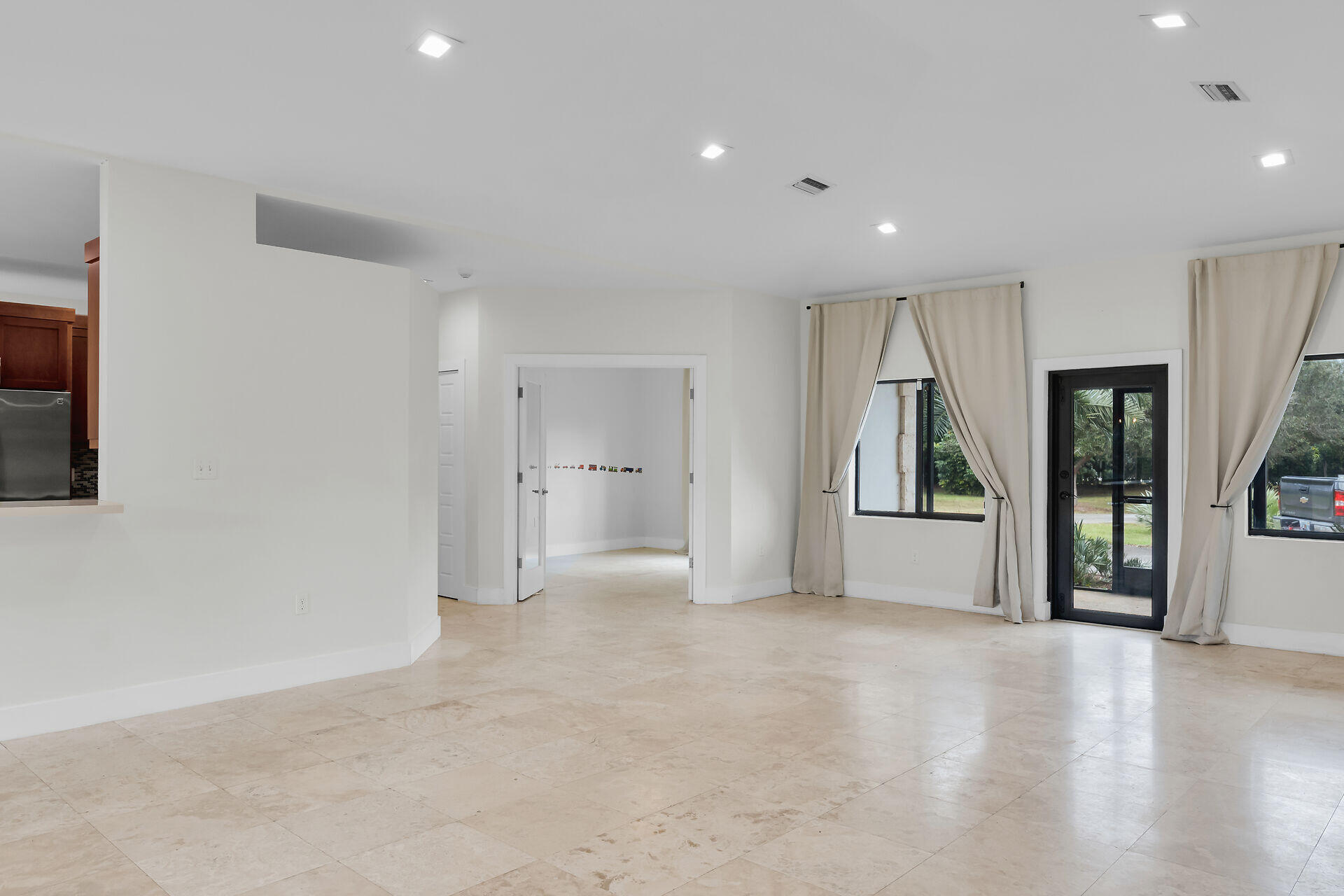 19900 Southwest 280th Street Homestead, FL 33031 - Photo 20 of 52 a view of a big room with windows and chandelier