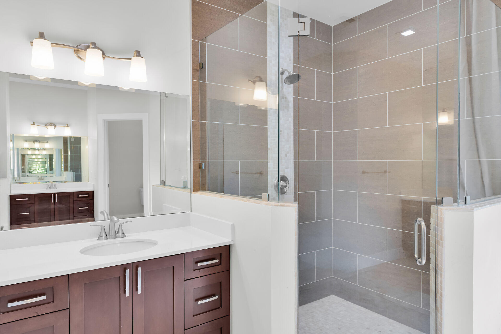 19900 Southwest 280th Street Homestead, FL 33031 - Photo 46 of 52 a bathroom with a granite countertop sink a mirror and a shower