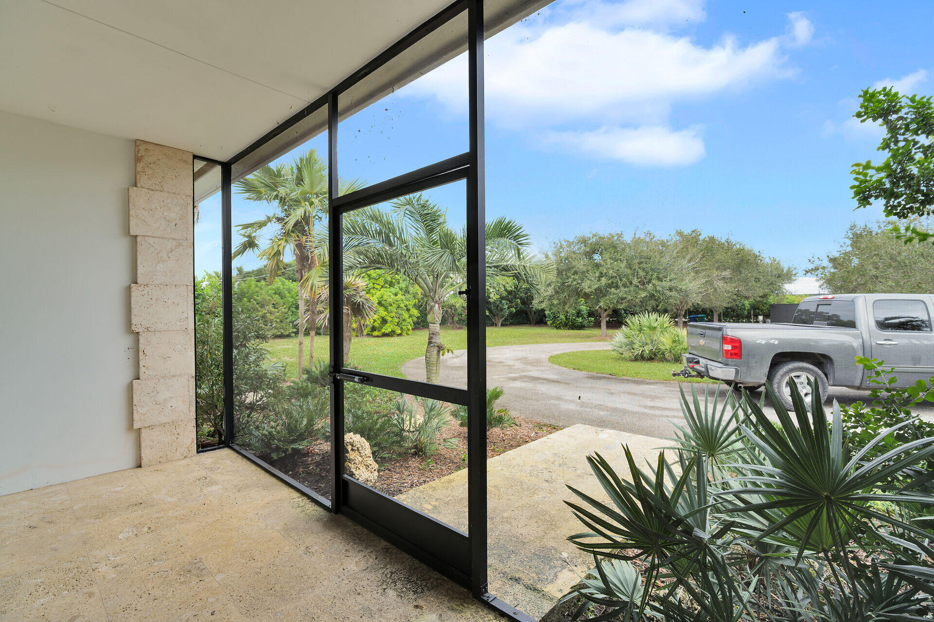 19900 Southwest 280th Street Homestead, FL 33031 - Photo 52 of 52 a view of a floor to ceiling window and an outdoor kitchen