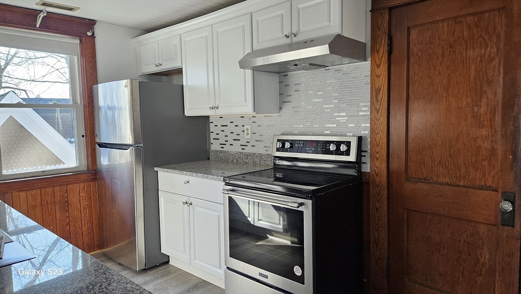 a kitchen with a stove microwave and refrigerator