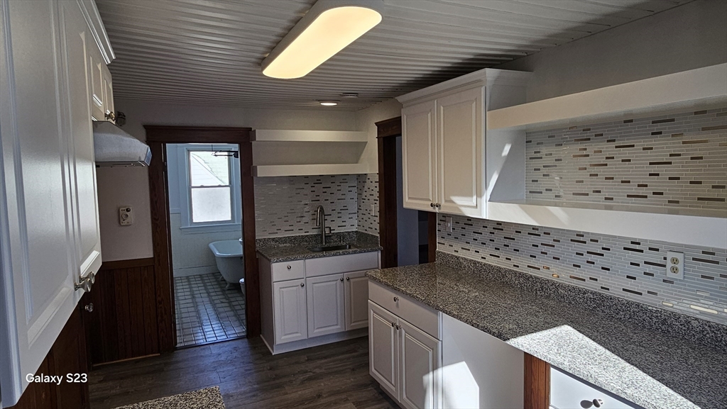 17 Cleveland Avenue, Unit 3 Worcester, MA 01603 - Photo 12 of 25 a kitchen with stainless steel appliances granite countertop a sink a stove and wooden floor