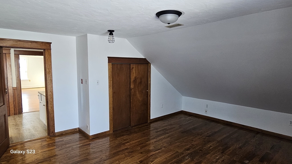 17 Cleveland Avenue, Unit 3 Worcester, MA 01603 - Photo 22 of 25 a view of an empty room with wooden floor and a window