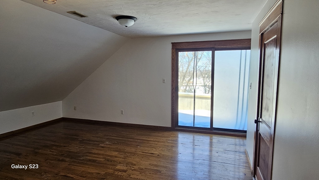 17 Cleveland Avenue, Unit 3 Worcester, MA 01603 - Photo 23 of 25 a view of an empty room with wooden floor and a window