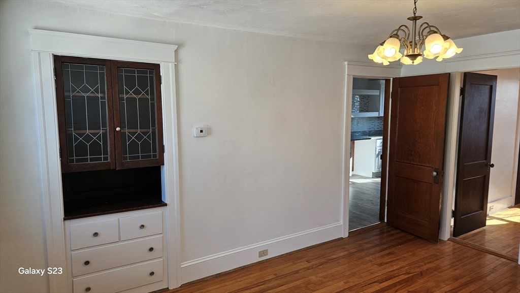 17 Cleveland Avenue, Unit 3 Worcester, MA 01603 - Photo 8 of 25 a view of a hallway with wooden floor and chandelier
