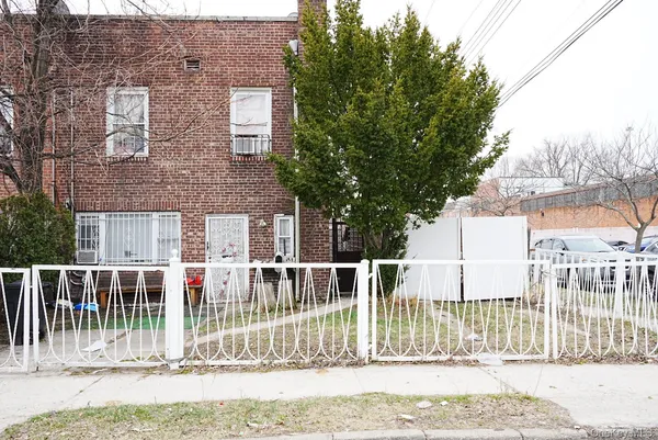a view of a house with a fence