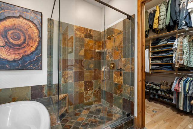 4892 Eagle Rdg Drive Eden, UT 84310 - Photo 23 of 39 Walk-in shower featuring multi-toned slate tile, a glass enclosure, and a built-in wooden bench