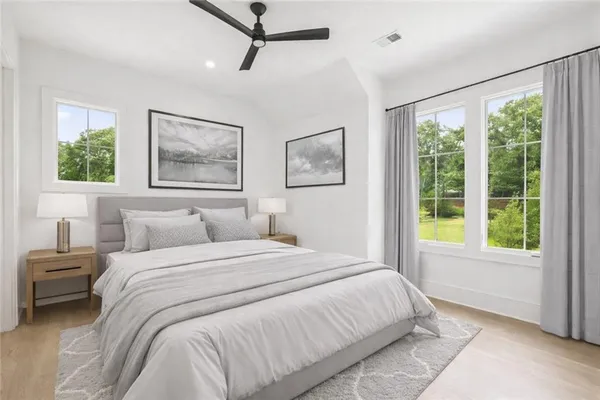 a bedroom with a large bed and a painting on the wall