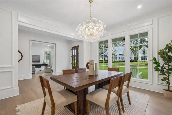 a view of a a dining room with furniture window and wooden floor