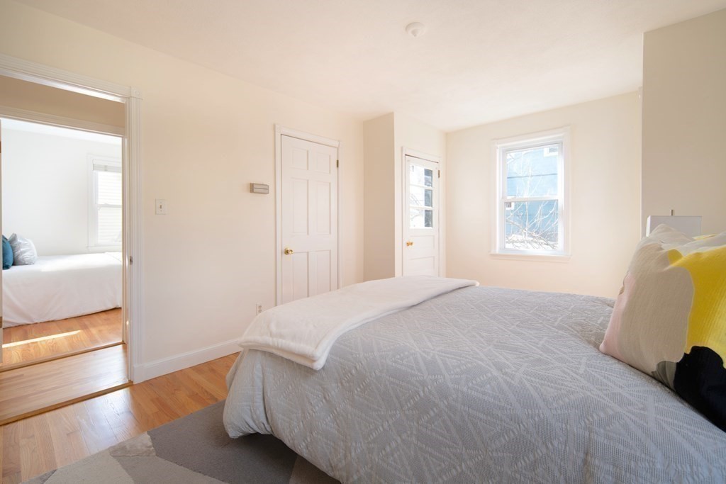 63 Reed Street, Unit 63 Cambridge, MA 02140 - Photo 11 of 16 a bedroom with a bed and a window