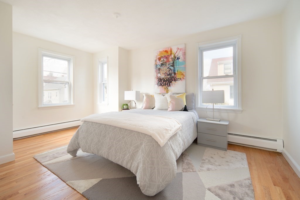 63 Reed Street, Unit 63 Cambridge, MA 02140 - Photo 12 of 16 a bedroom with a bed and a window